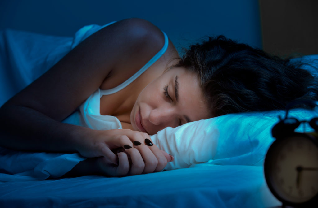 Woman wearing a night guard while she sleeps. 