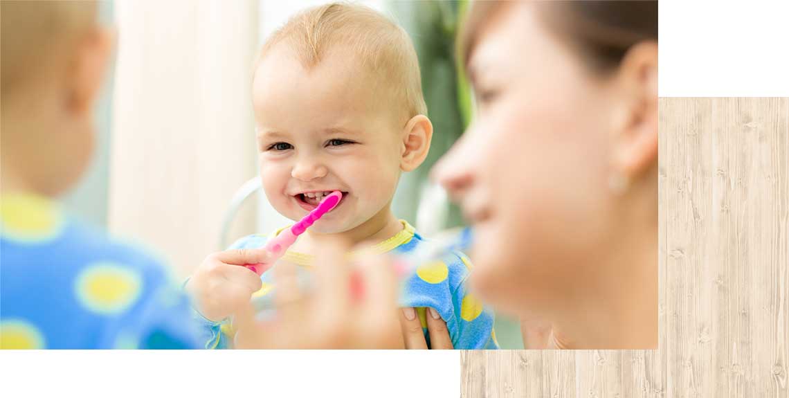 child brushes his teeth