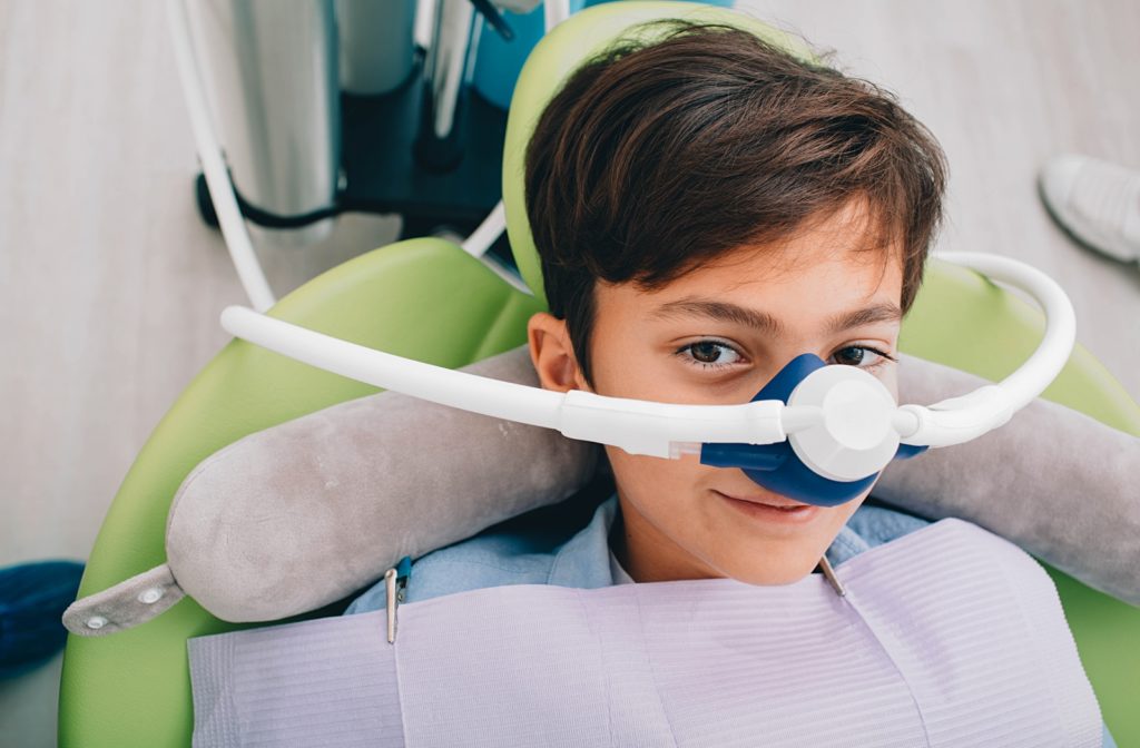 A young boy sitting in the dentist's chair getting ready to undergo his sedation procedure