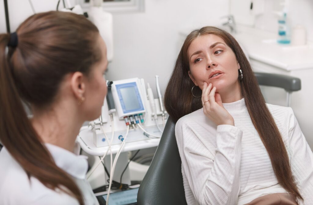 A person discusses their TMJ pain with their dentist.