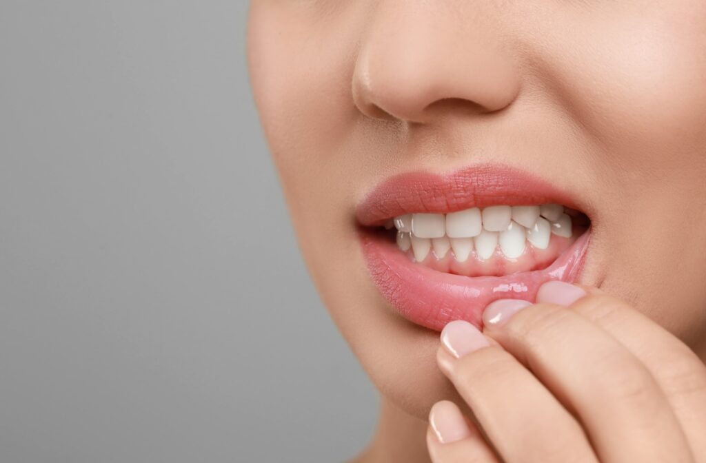 A person pulling down their lip to expose their gum line