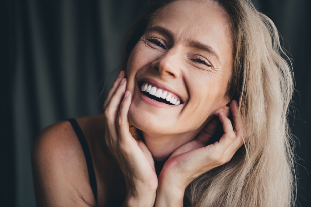 A person smiling with perfect veneers
